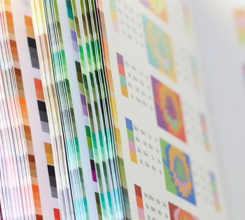 Multicoloured printing paper in a big sheaf.