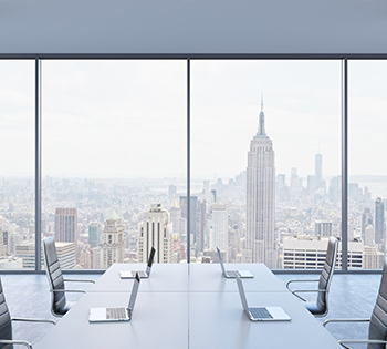 A meeting room with a cityscape view