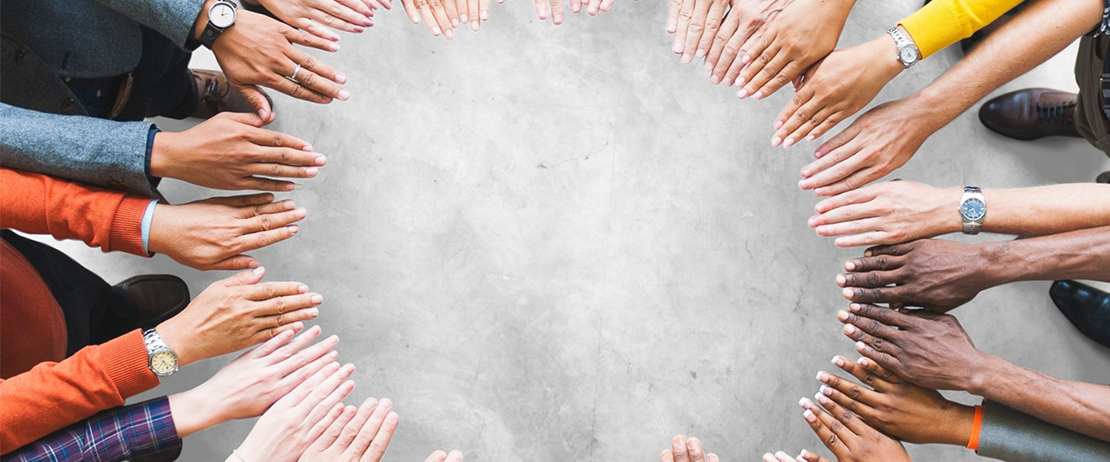 People holding their hands in a circle