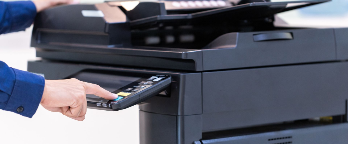  An employee diagnoses a copier machine to see if it’s hacked.