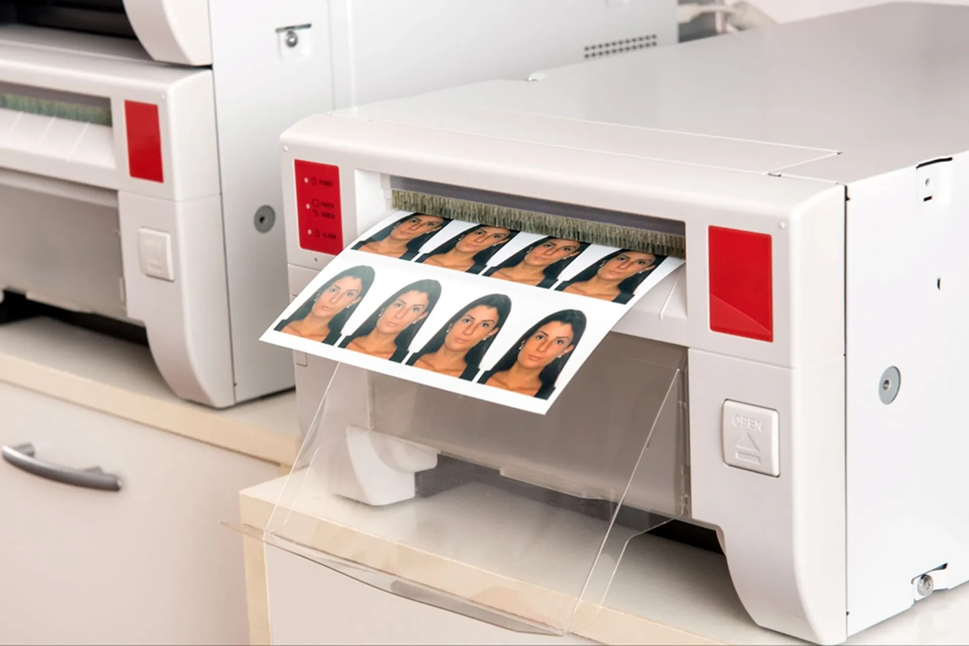 A printer produces a full-colour print of a woman’s passport photo