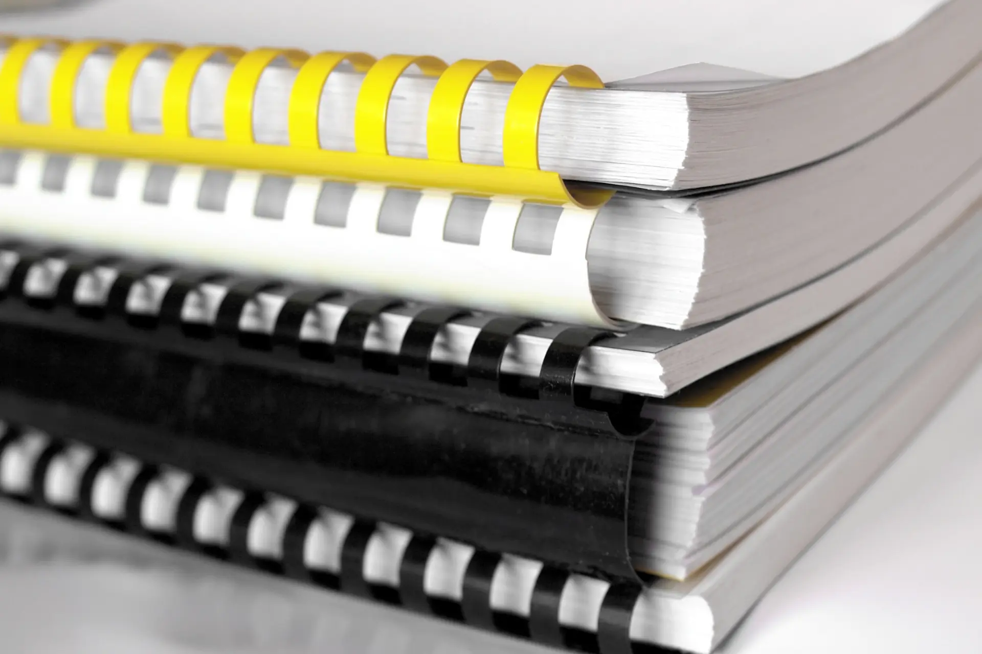 A stack of paper binder books